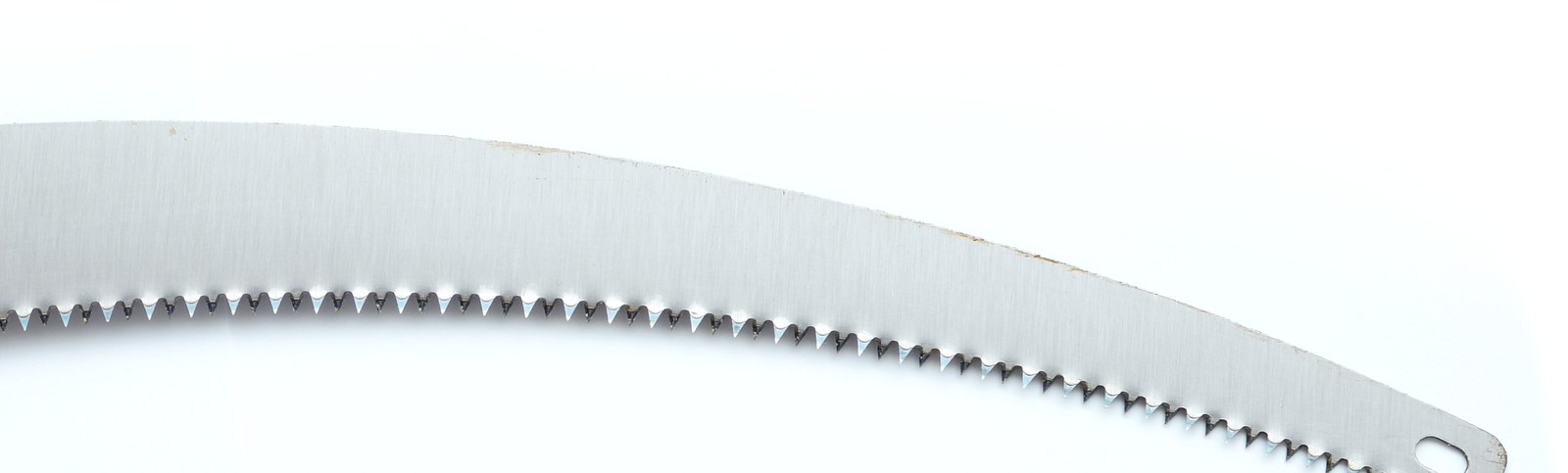 Close view of a pruning saw blade showing the darker hardened band along the teeth