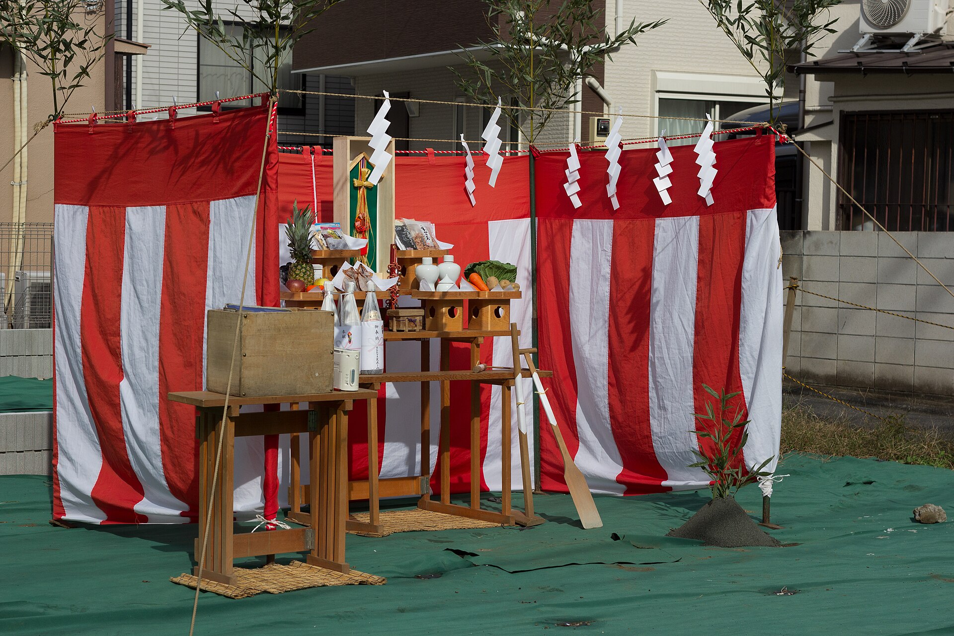 A groundbreaking altar enclosed by green bamboo with paper shide