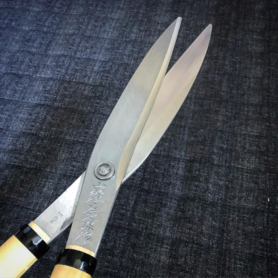 Close-up of a smith's mark struck into the blade of Japanese shears
