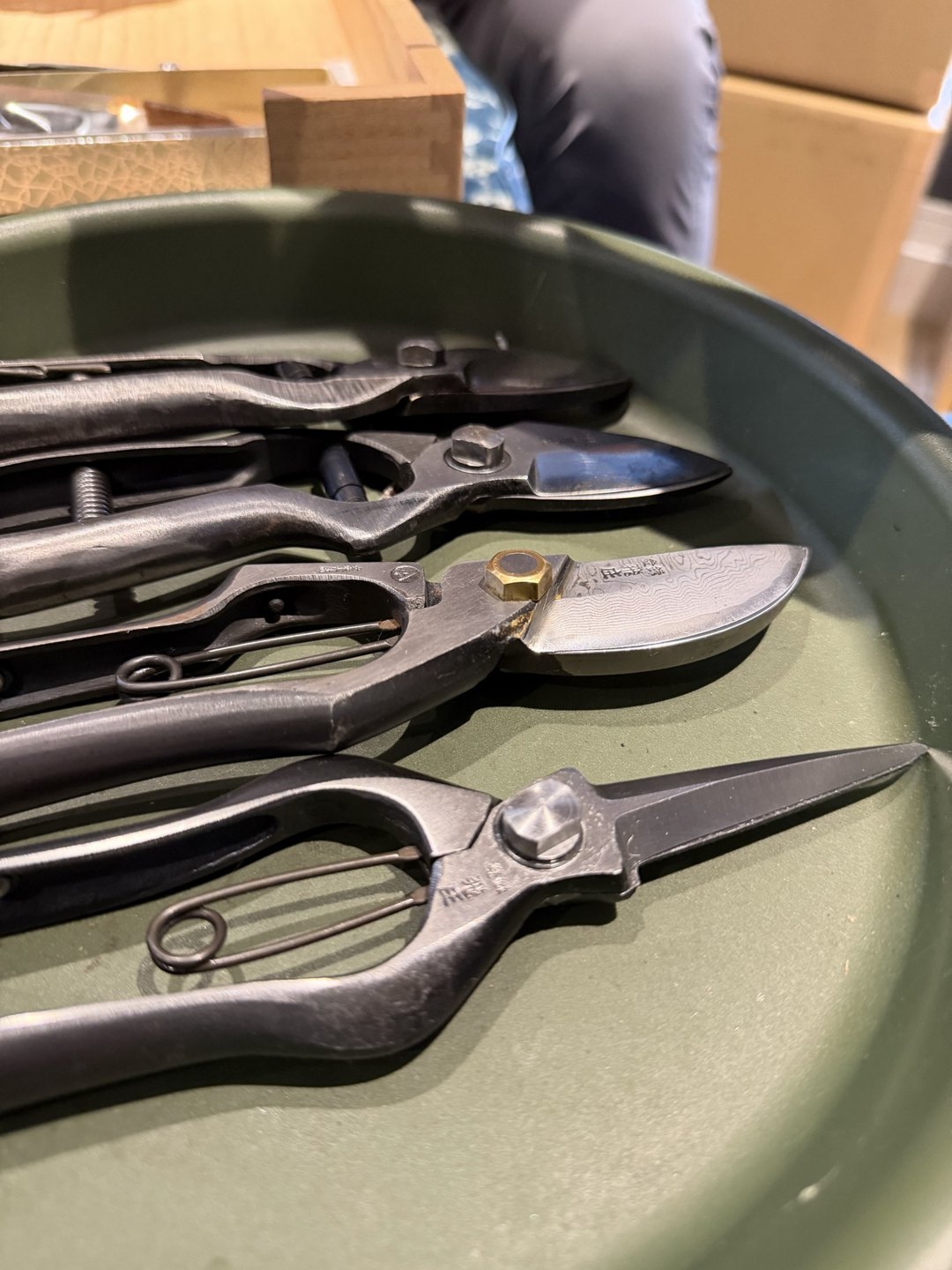 Pruning shears lying in a green tray, seen up close
