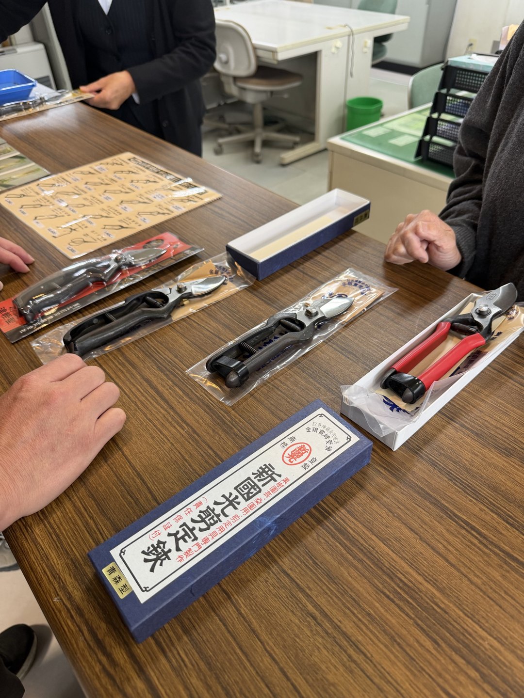 Boxed shears laid out on a shop table, seen from another angle